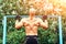 Closeup of strong bald athlete doing pull-up on horizontal bar. back view.