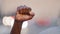 Closeup strong clenched male fist raised up. Black African American adult mature man demonstrates protests against