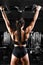 Closeup Strong girl in sportswear doing pull up exercises on horizontal bar. A snapshot from the back, copies of the