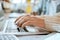 Closeup, student hands and typing on laptop at desk for studying, planning and learning for goals. Man, keyboard and