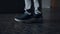 Closeup student legs walking on marble school floor. Boy going on empty corridor