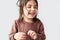Closeup studio horizontal portrait of happy cute little girl smiling joyful and wearing sweater isolated on a white studio