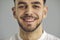 Closeup studio portrait of a happy young Caucasian man with a friendly open smile