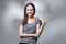 Closeup studio portrait of young woman in grey shirt