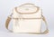 Closeup studio shot of cream and beige color multifunction multipurpose utility compartments zipper newborn baby toddler mommy bag