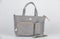 Closeup studio shot of gray color multifunction multipurpose utility zipper newborn baby toddler mommy handbag with milk bottle