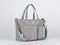 Closeup studio shot of gray color multifunction multipurpose utility zipper newborn baby toddler mommy handbag with milk bottle