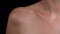 Closeup studio shot of young girl body part, clavicle shoulder neck area smooth skin, visible breathing.