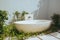 Closeup of a stylish interior open-air ceramics bathtub surrounded with plants