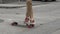 Closeup of a stylish man stepping onto a skateboard