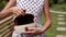 Closeup of stylish rattand handbag in the tropical garden.