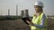 Closeup of successful worker engineer woman using digital tablet inspecting industry oil and gas power plant -