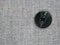 Closeup of suit button for business or formal wear. Gray fabric for tailoring. The grey pinstripe suit cloth. Texture of