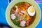 Closeup sukhothai Noodle with spicy soup in vintage bowl. Thai food style