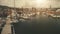 Closeup sun harbor dock with yachts aerial. Ships and sailboats at sunlight marina on ocean bay