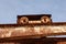 Closeup of a sunlit old rusty port crane with clear sky background