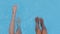 Closeup suntanned slender beautiful female legs swinging shaking making wave in blue summer swimming pool. lady foot