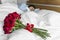 Closeup of a surprise red rose bouquet on bed for wife