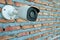 Closeup Surveillance Camera or cctv of security on newly built red brick wall