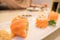 Closeup Sushi roll with fresh salmon In white plate . Japanese style Food