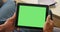 Closeup of tablet with greenscreen