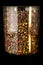 closeup tall glass jar with assorted peppercorns