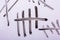 Closeup of tally marks written with black pen on a whiteboard - counting concept