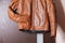 Closeup of Tanned Leather Stylish Motorcyclist Jacket Hinged Over Sliding Door Holder