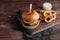 Closeup of a tasty Burger with appetizers such as fried onion rings with a white garlic sauce. Juicy Burger with bacon and cheese