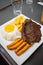 Closeup of a tasty looking breakfast with a steak and french fries