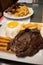 Closeup of a tasty looking breakfast with a steak and french fries