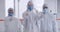 Closeup of a team of microbiologists approving after completion of sanitizing the area. A group of scientists in hazmat