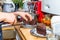 Closeup teen boy hands cutting chocolate cake on plate on wooden board with knife