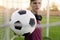 Closeup Teen holding soccer ball in the goal