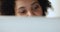 Closeup teen mixed race female eyes looking on pc monitor