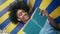 Closeup teen reading book aloud lying on bench outdoors. Girl enjoy literature