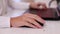 Closeup of teenage boy playing game on his pc computer in white room. Focus on hand with computer mouse