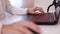 Closeup of teenage boy playing game on his pc computer in white room. Focus on hand with computer mouse