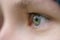 Closeup of teenage girl eye without makeup looking straight outdoors