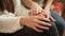 Closeup of teenage girl stroking her friend& x27;s hands. Friends support and teenager depression