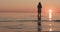 Closeup teenage girl walking in shallow water on a beach