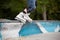 Closeup of teenager`s rollers on the edge of parapet. Child performing stunts on roller skates.Sport and leisure concept