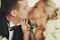 Closeup of tenderly kissing wedding couple