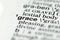 closeup of term and definition of grace printed in dictionary on white page.