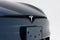 Closeup of the Tesla Model S Plaid front view logo on a white background