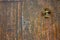 Closeup texture of an old wooden door with flower cross decoration