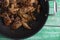 Closeup of a thai recipe with caramelized chicken wings in a wok
