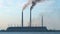 Closeup of thermal power plant high pipes with black smoke moving upwards polluting atmosphere. Production of electrical