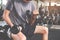 Closeup of a thin man doing exercises with dumbbell. Fitness muscular body. Fitness concept