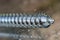 Closeup of the thread of a galvanized wood screw